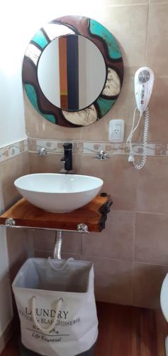 a bathroom with a sink and a mirror on the wall at Balcon de Antares in Uspallata