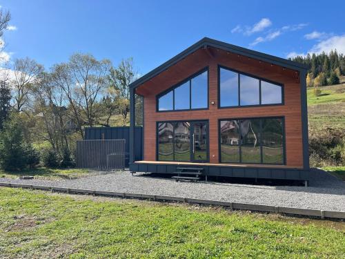 a small house with glass windows on a hill at pro100 house in Volosyanka