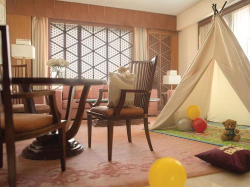 a room with a table and chairs and a teepee at Jumeirah Messilah Beach Kuwait in Kuwait