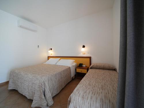 Ένα ή περισσότερα κρεβάτια σε δωμάτιο στο LUZIA AGRIRESORT Amazing Nature Atmosphere