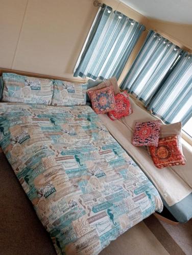 a bed with pillows on it in a bedroom at L91 Rebecca's place in Mablethorpe