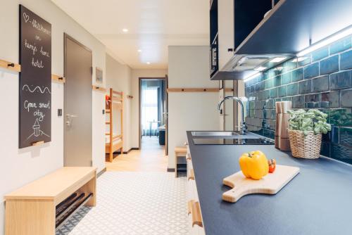 a kitchen with a counter with a pumpkin on the counter at harry's home Graz-Smart City hotel & apartments in Graz