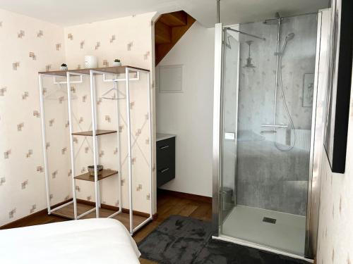 une douche avec une porte vitrée dans une pièce dans l'établissement Grande maison en campagne avec piscine, 11 voyageurs, à Hénansal
