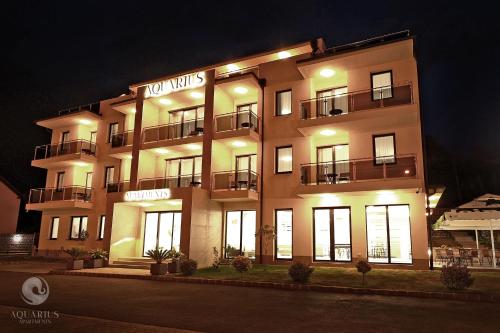 a large building with lights on it at night at Aquarius Apartments in Miskolctapolca