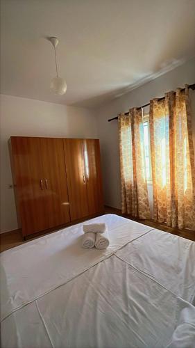 a bedroom with a bed with a towel on it at Vila Luani 1 in Vlorë