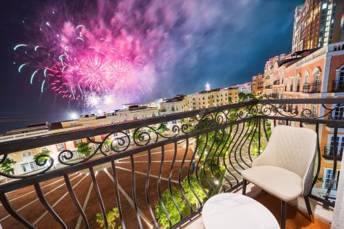 a balcony with a view of a fireworks display at Novus Sol Hotel & Apartment Sunset Town Phu Quoc in Phu Quoc