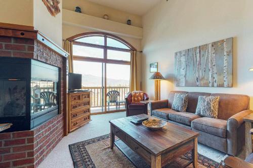 a living room with a couch and a fireplace at Dillon Commons Studio in Dillon