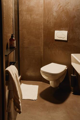 a bathroom with a toilet and a sink at Raibu Ghent by StayC in Ghent