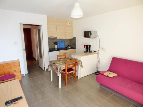 un salon avec un canapé rouge et une table dans l'établissement Vue mer, calme, face à la plage, à Saint-Elme