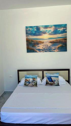 a white bed with two pillows on top of it at Vila Luani 1 in Vlorë