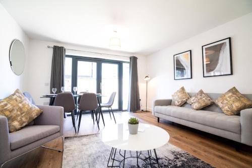 a living room with a couch and a table at 4 Bedroom City Centre Townhouse in Norwich