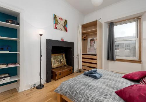 a bedroom with a bed and a fireplace at The Lothian Road Residence in Edinburgh