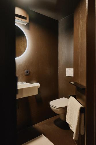 a bathroom with a toilet and a sink at Raibu Ghent by StayC in Ghent