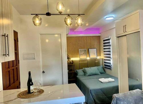 a small living room with a bed and a table at Almond Drive Talisay in Tangke