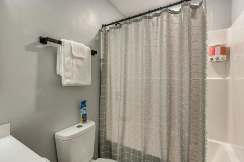 a bathroom with a shower curtain and a toilet at 3 Mi to Navarre Beach Home with Furnished Patio in Navarre