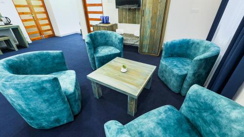 a waiting room with blue chairs and a table at Hasthi Boutique in Kandy