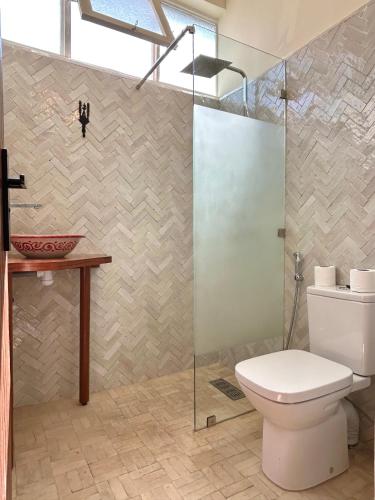 a bathroom with a toilet and a glass shower at Appartements Balima Résidences Sidem in Rabat