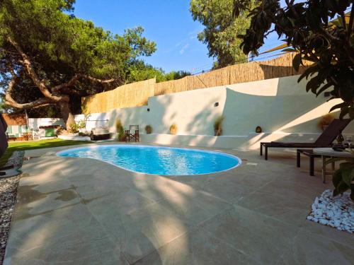 a swimming pool in the middle of a patio at Cozy Mama Evas Homestay with Pool and Garden for Groups of 4 in Kirás Vrísi