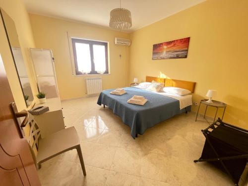 a bedroom with a bed and a chair in it at Sicily Holiday Home in Termini Imerese