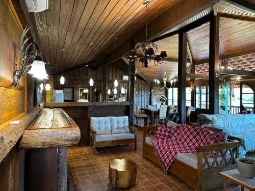 a living room with a couch and a dining room at Villa Italia hospedagem in Gramado