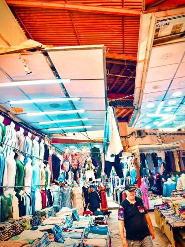 a man is standing in a store with a clothes shop at Hotel afriquia in Oujda