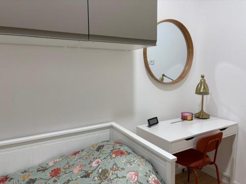 a bedroom with a bed and a desk with a mirror at Apartment Gold Wing Sinj in Sinj