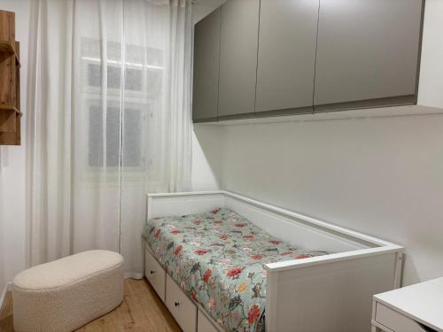 a small bedroom with a bed and a chair in it at Apartment Gold Wing Sinj in Sinj
