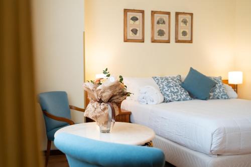 a living room with a couch and a table at Hotel Royal Palace in Messina
