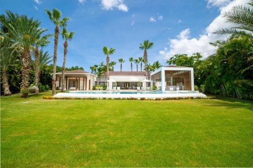 an exterior view of a house with a large yard at Casa Della Luna in La Romana
