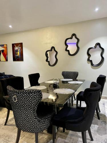 a dining room with a table and chairs at Alluvia Residences in Lagos