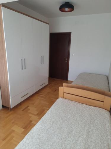 a bedroom with two beds and a closet at Luxury Apartment in Strumica
