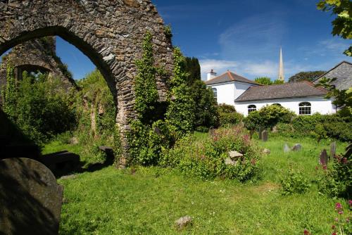 an old stone bridge in front of a house at The School House, Patricks Square, Wexford Town in Wexford