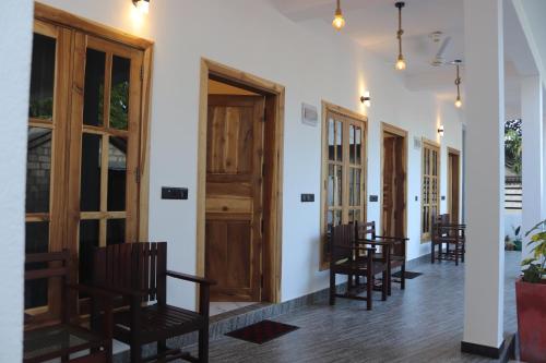 a row of chairs in a room with a door at Elite Bay Arugambay in Arugam Bay