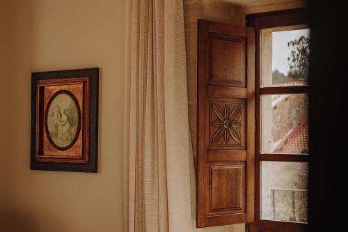 a wooden door with a picture next to a window at Hotel Palacio de Caranceja in Reocín
