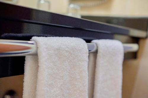 a group of towels hanging on a towel rack at Welcome Parkhotel Bochum in Bochum