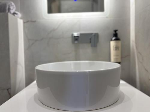 a white sink sitting on a counter in a bathroom at Samel Hotel in Siviri