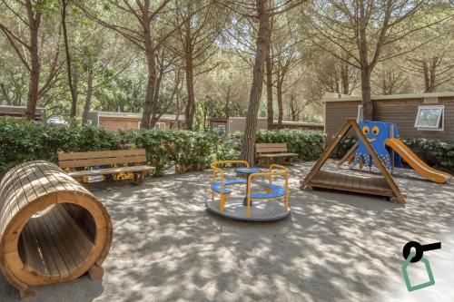 a playground with a slide and a swing set at HOTIDAY Lodge Castiglione in Castiglione della Pescaia