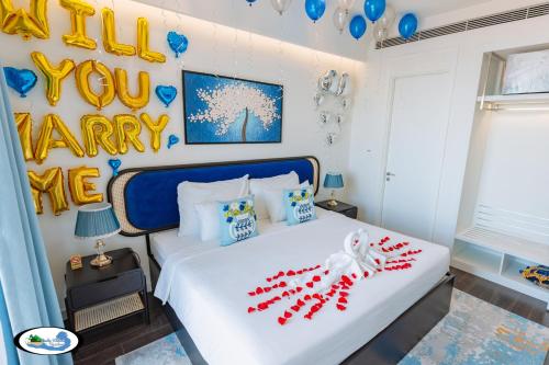 a bedroom with a bed with a happy new year decoration at Oscar Seaview Apartment in Phu Quoc