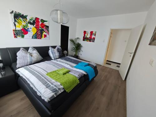 a bedroom with a bed with a green blanket at Großzügige Wohnung mit Terrasse in Zeltweg