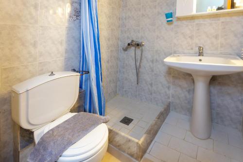 a bathroom with a toilet and a sink at Melissa Gold Coast in Psakoudia