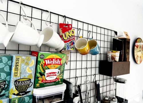 a kitchen counter with a rack of food and drinks at The Larch in Hensol