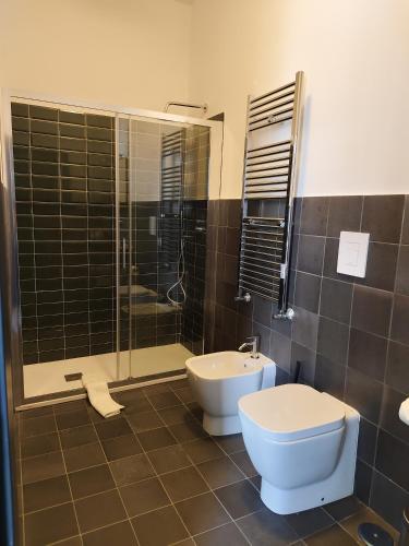 a bathroom with a toilet and a shower and a sink at Altoledo Rooms and Suite in Naples