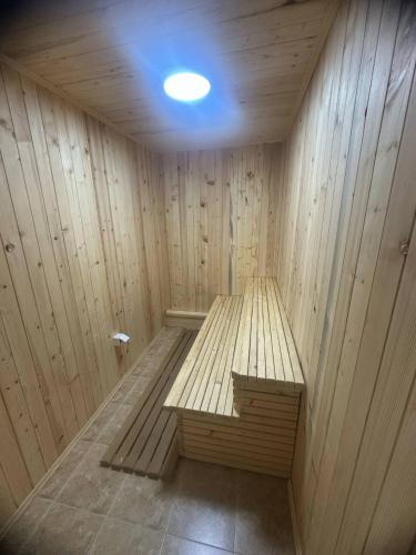 a wooden sauna with a bench in the middle at Apartmani Jovanovic Mala Reka BB in Bajina Bašta