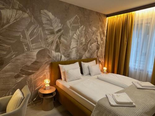 A bed or beds in a room at Grand Suites Corvin