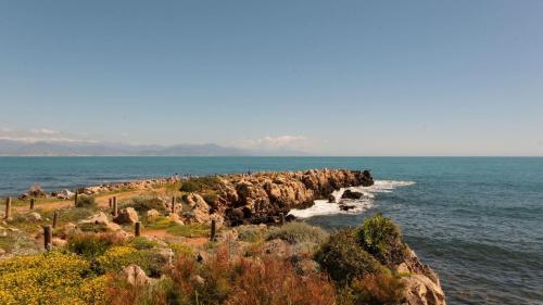 a group of people standing on a rocky beach at Villa Miraé by Inwood Hotels - Cap d'Antibes in Antibes