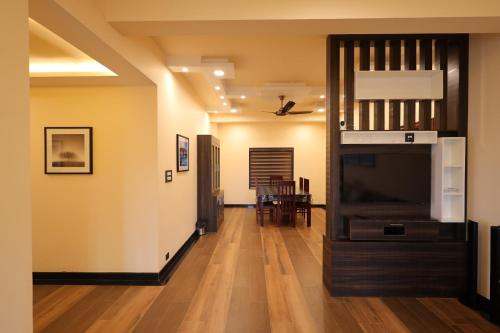 a hallway with a living room and a dining room at Plachoos Gardens - A luxury serviced villa in Kuttikkanam, Peermede in Pīrmed