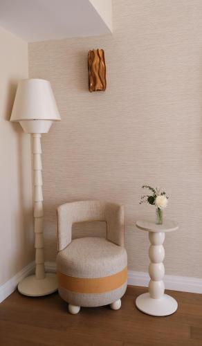 a room with a chair and a lamp and a table at Villa Miraé by Inwood Hotels - Cap d'Antibes in Antibes