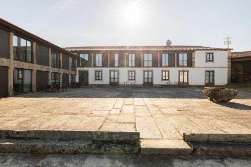 a large courtyard with a large building with windows at CasaNova Farmhouse in Braga