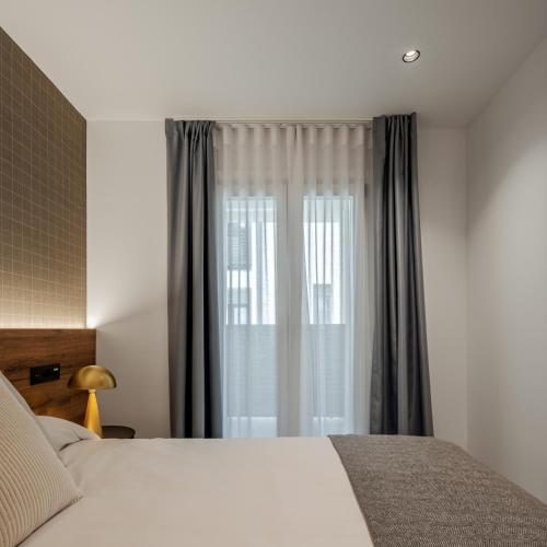 Кровать или кровати в номере Apartamentos Turísticos de Soria 36 Collado