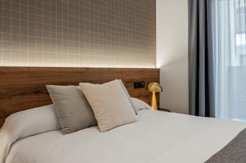 Кровать или кровати в номере Apartamentos Turísticos de Soria 36 Collado